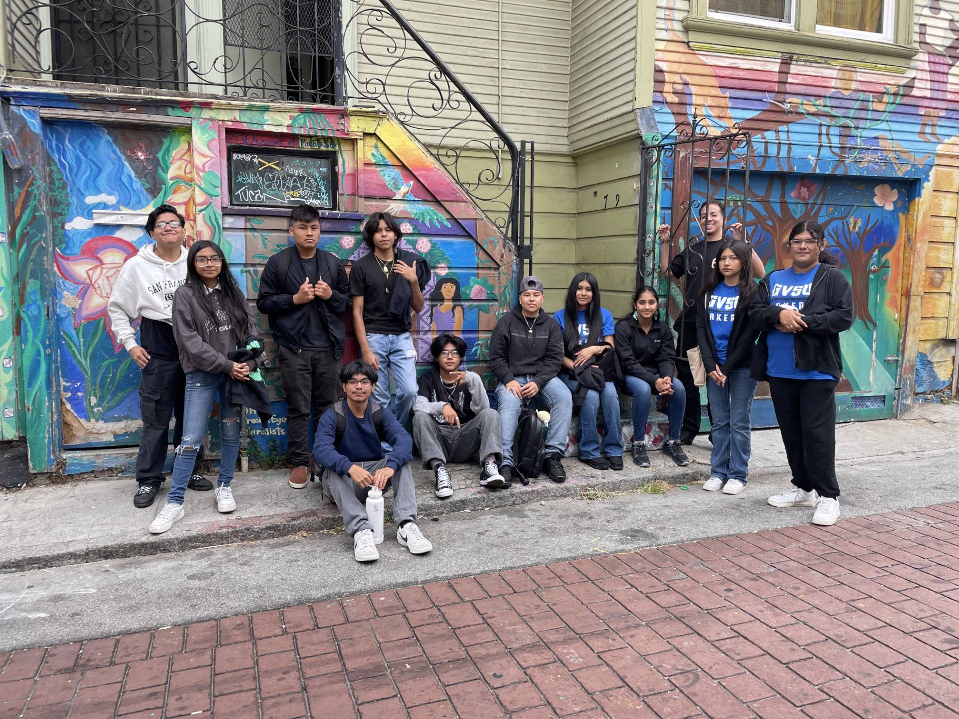 group of students posing for the camera while visiting Mission Alley in San Francisco